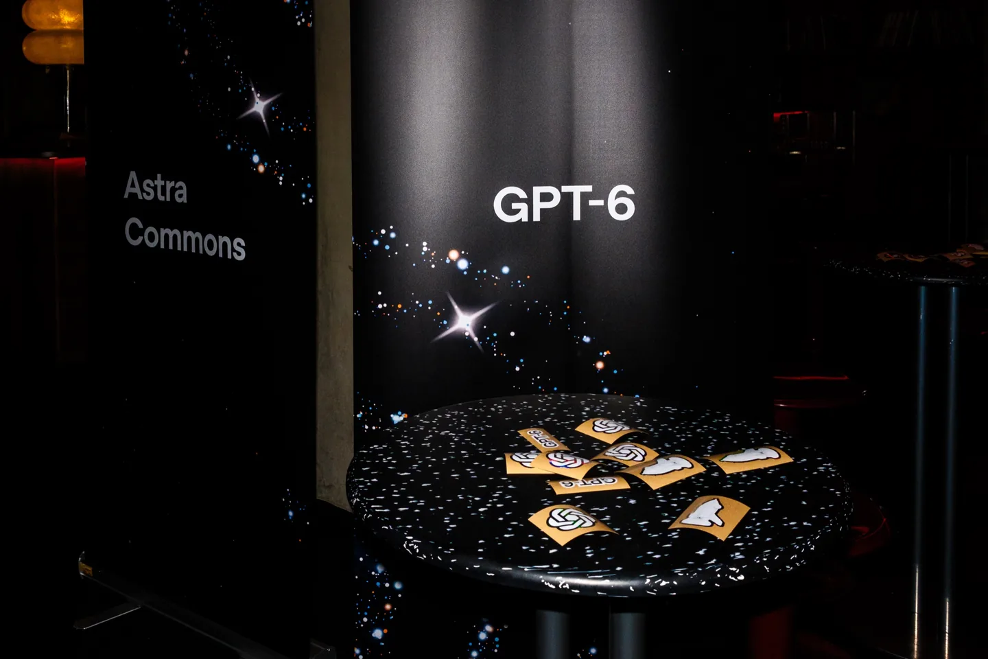 Astra Commons event display with GPT-6 signage and OpenAI stickers