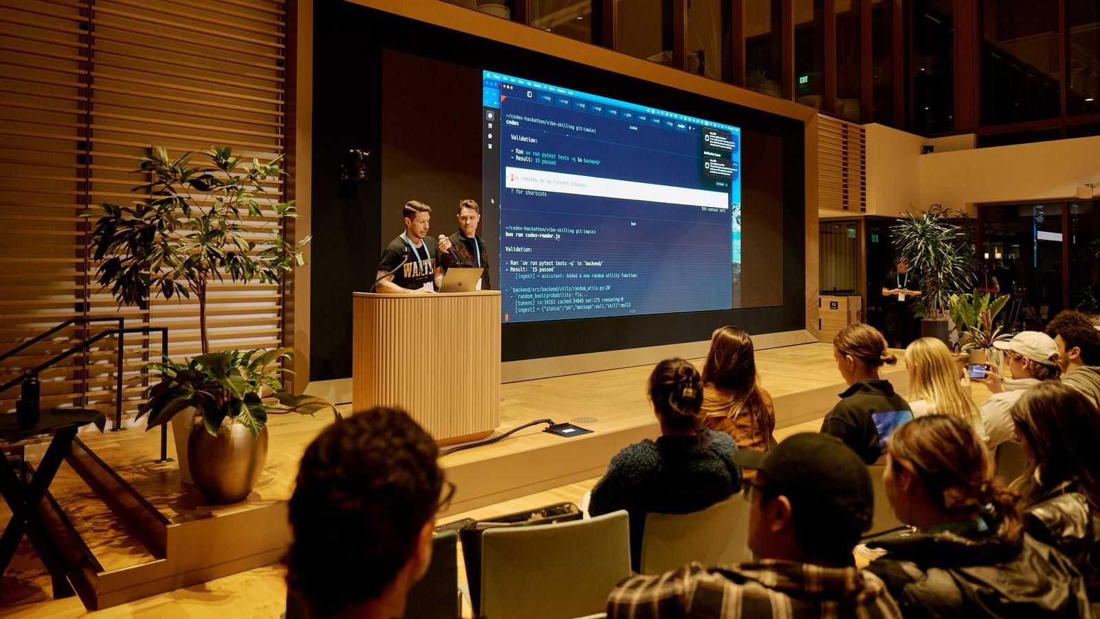 Presenters on stage at the OpenAI Codex Hackathon